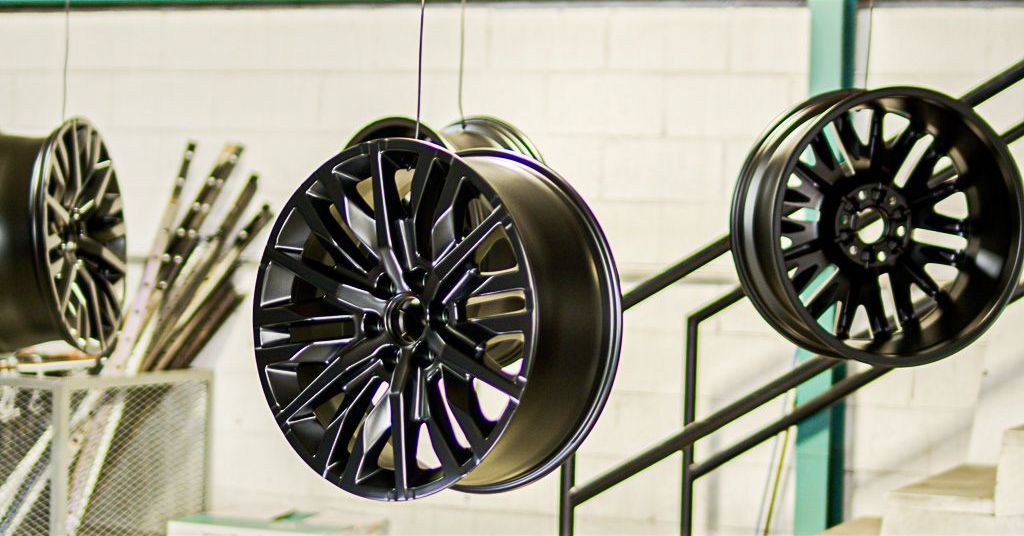 Finished powder coated wheel rim hanging in the Colortec shop